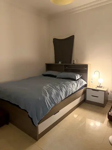 Queen bed frame with mattress and bedside drawer plus two closets - light wood