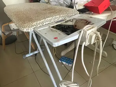 Used ironing board with built-in iron holder