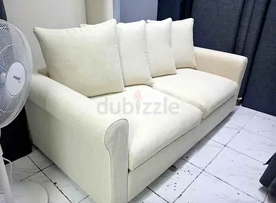 Cream 2-seater Fabric Sofa bed with 4 Cushions - Good Condition