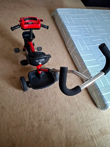 Red toddler tricycle with push handle - good condition