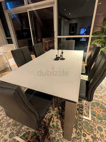 Modern white glass dining table with 6 grey faux leather chairs