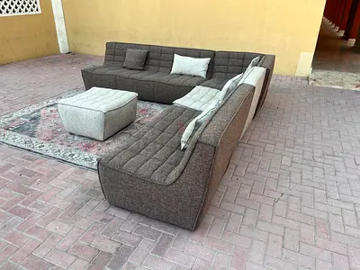 Excellent condition Al Huzaifa Modular feather filled sofa with ottoman