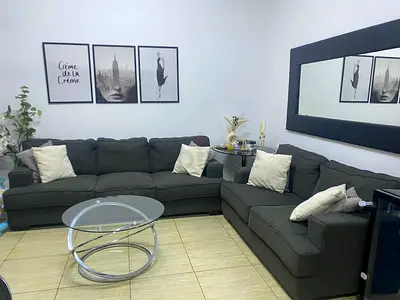 Dark grey L-shaped sofa set with cushions - good condition