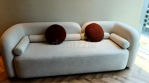 Modern Off White Boucle Sofa with Round Brown Pillows