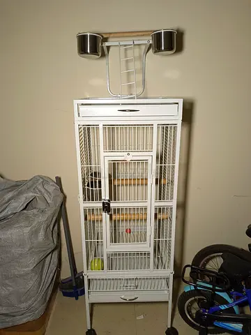 White metal bird cage with stand and feeding bowls - good condition