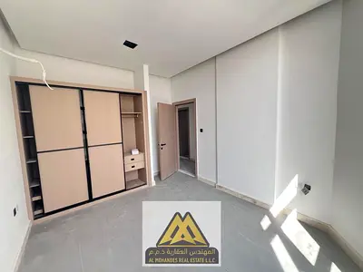 1BR first-tenant apartment in Al Nuaimiya, Ajman, 2 baths, balcony, central AC, AED 35K, 4 payments.