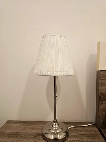 Simple chrome table lamp with white pleated shade