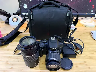 Canon EOS 1300D DSLR kit with two lenses, charger and camera bag