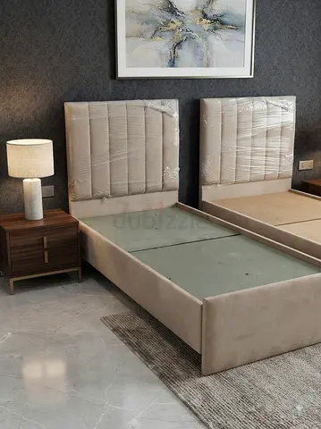 New beige upholstered single beds with padded headboards