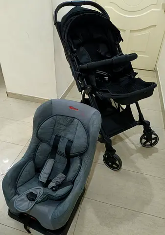 Lightweight black stroller with matching infant car seat - good condition