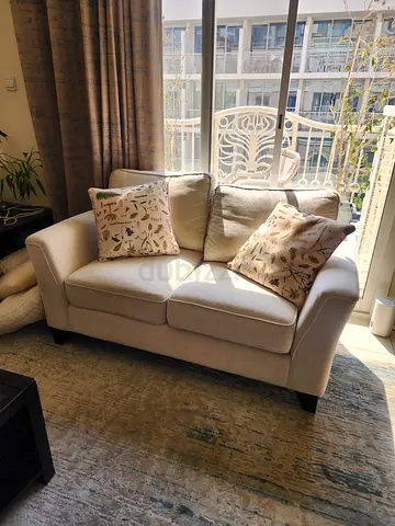 Light beige 2-seater sofa in excellent condition