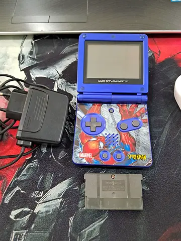 Nintendo Game Boy Advance SP (Spider-Man faceplate) with charger and game