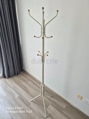 Free-standing metal coat rack with wooden knobs — good condition