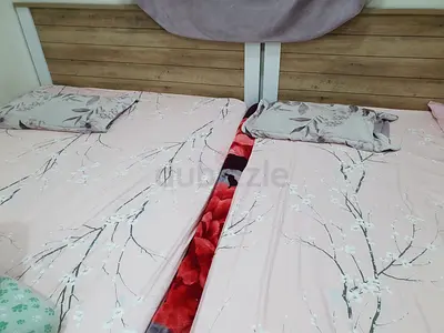 Two single beds with headboards and mattresses - used