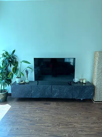 Black modern TV console with 4 storage shelves-  good condition.