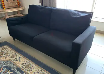 2-seater black fabric sofa in good condition