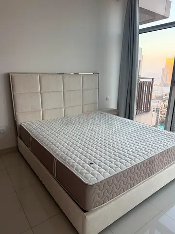 Queen size upholstered bed frame with mattress. Great condition, comes with mattress and side table
