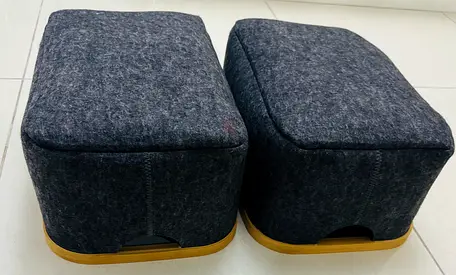 Pair of small upholstered footstools/ottomans - dark grey, wooden base