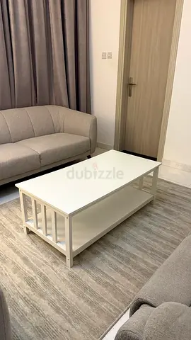 White wooden coffee table with lower shelf — good condition