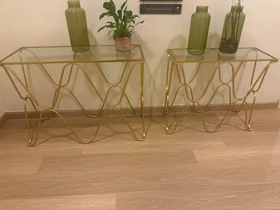 Pair of gold metal glass-top side tables — modern decorative consoles