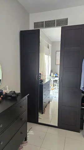 IKEA black solid wood closet in excellent condition with 3 doors.