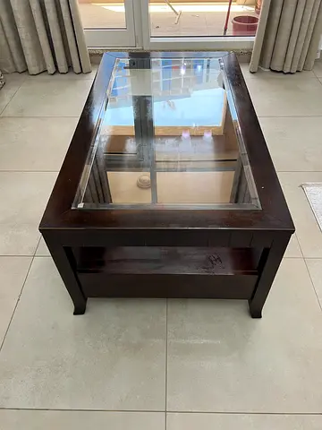 Dark wood coffee table with glass top