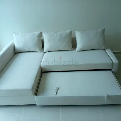 Light beige L-shaped pull-out sofa bed with storage - good condition