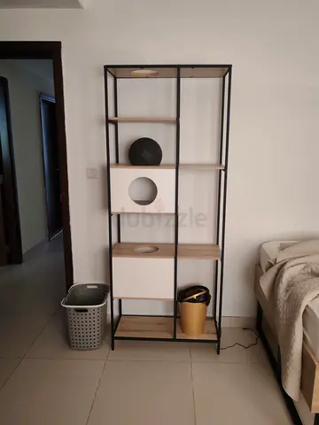 Tall industrial-style shelving unit with wooden shelves and storage cubes
