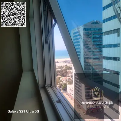 2BR hall in Ajman One Towers Rashidiya 3 with two balconies, great view, three bathrooms, store room, American kitchen; yearly rent AED 47,000, 4 paym