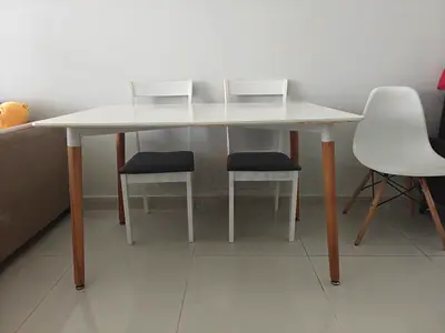 Simple white dining table with wooden legs - good condition, with two chairs