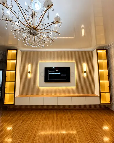 Custom built-in entertainment wall unit with illuminated shelving
