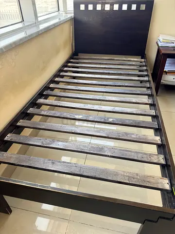 Single dark wood bed frame with headboard