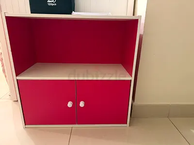 Small white and pink storage cabinet with doors - compact bedside or kids cupboard