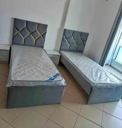 Pair of single beds with mattresses and headboards - grey