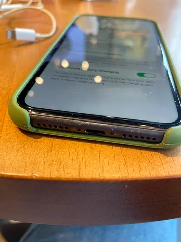 iPhone in green case with charger - good condition Battery is at 73!
