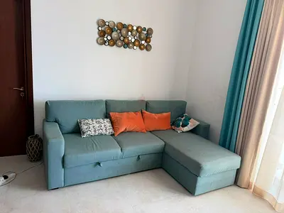 Light teal L-shaped sofa with storage, good condition