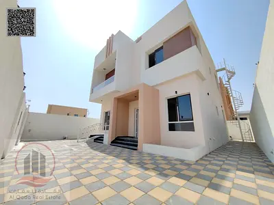Villa for sale in Ajman, Al Yasmin area, including electricity and air conditioning. 3 master bedrooms, living room, majlis, and maid's room.