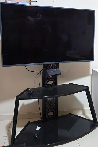 55" Lg Smart TV on Stand with Glass Shelves - Good Working Condition with tv box