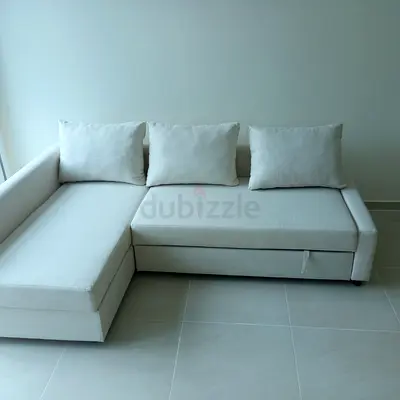 Light beige L-shaped sectional sofa with storage, good condition