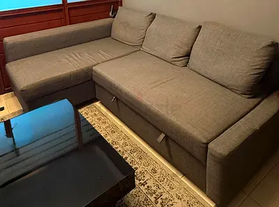 L-shaped grey fabric sofa with chaise and storage - good condition