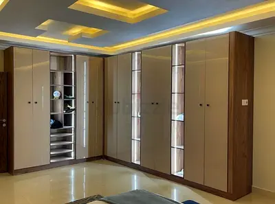 Large L-shaped Built-in Wardrobe with Glossy Cream Doors and Wood Trim