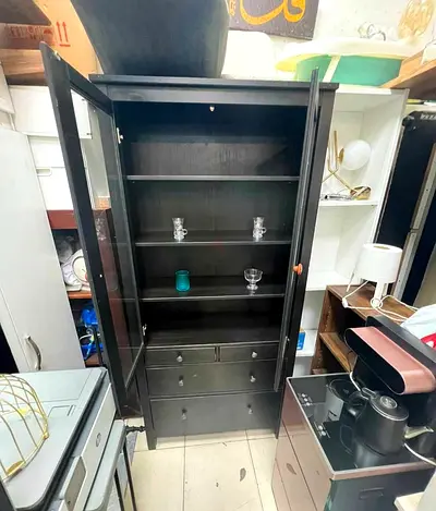 Tall Black Wooden Display Cabinet with Glass Doors and Drawers