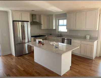 Modern white kitchen cabinets with island - and top marble