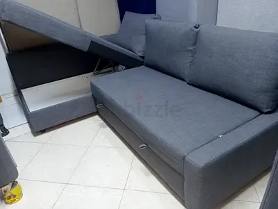 Grey fabric 2-seater sofa bed with storage - good condition