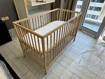Simple wooden baby crib with mattress - good condition