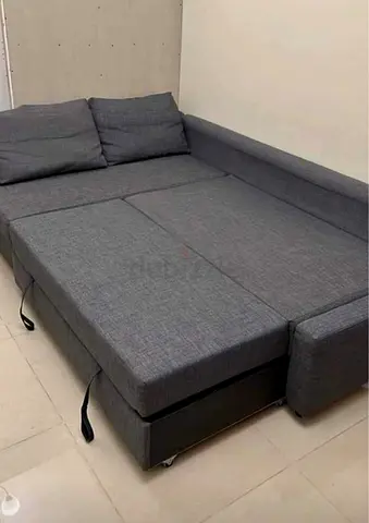 Grey L-shaped sofa bed with storage - good condition