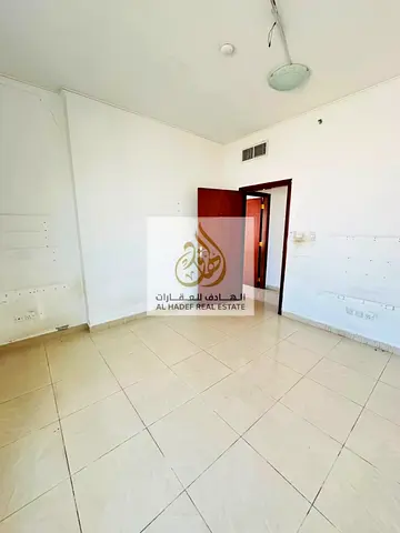 For annual rent in Al Majaz 2, a 3-bedroom apartment with a living room, balcony, and large storage room. High floor with a stunning view. Payments in