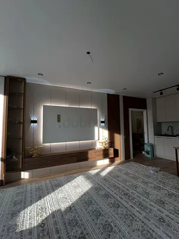Modern wall-mounted TV unit with integrated lighting and storage