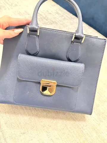 navy blue structured leather handbag with front pocket and gold clasp