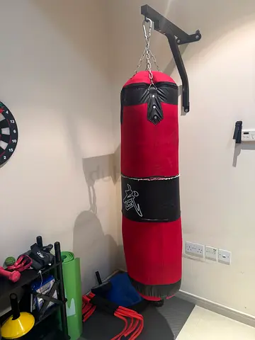Heavy duty red punching bag with wall mount and chains